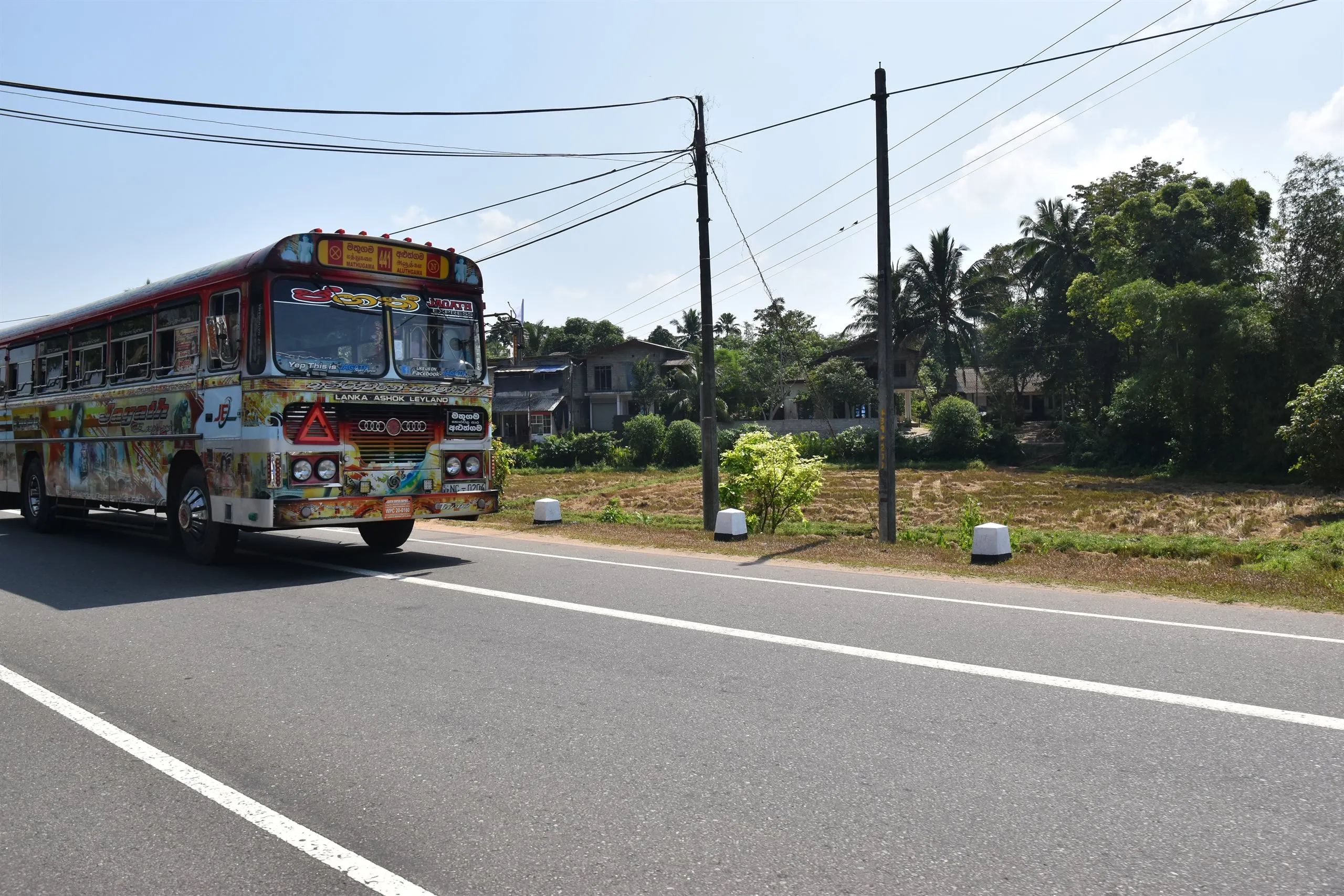A local bus painted from bumper to roof on the coast road