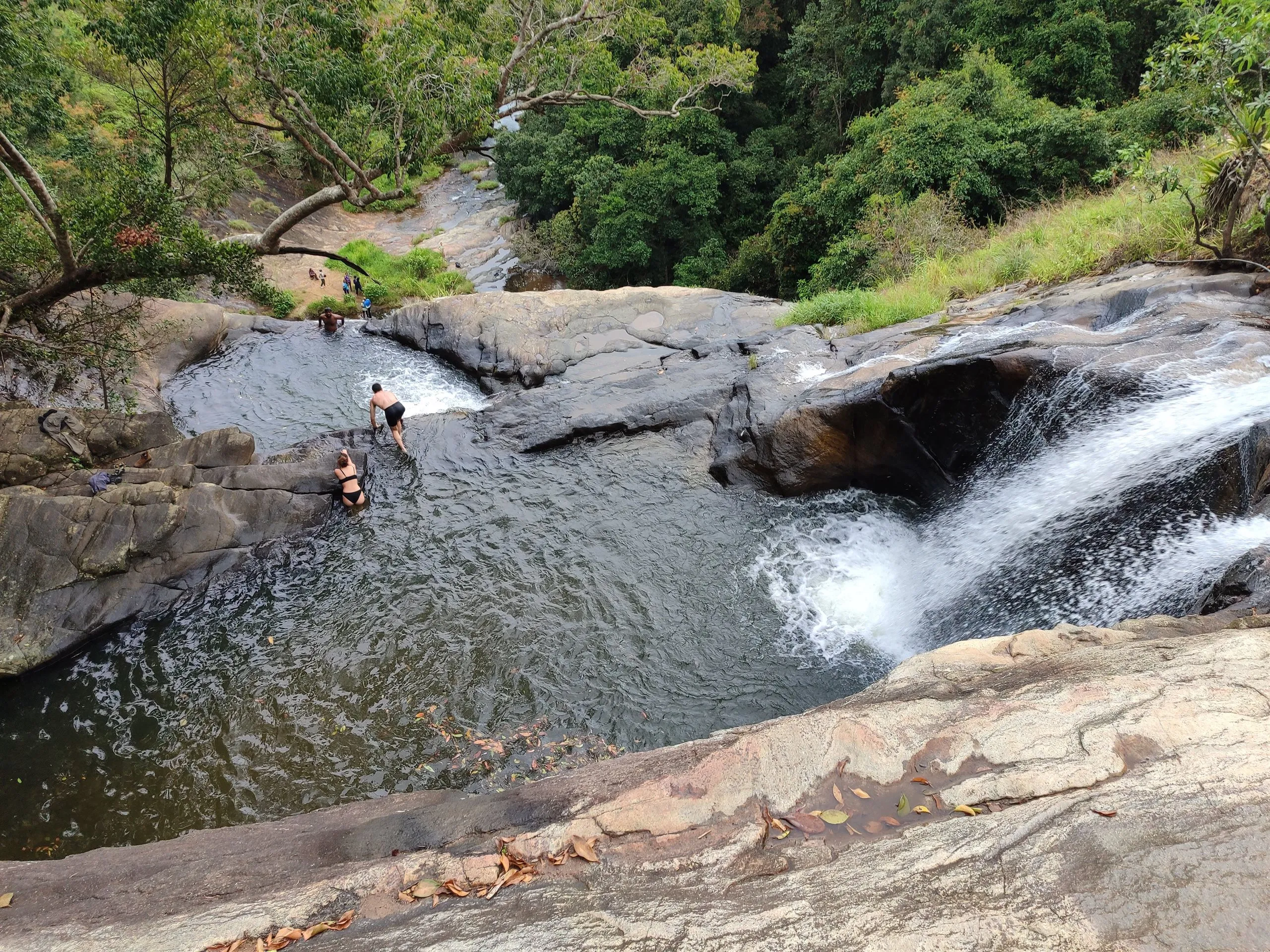 Swimming in the lagoon below a waterfall