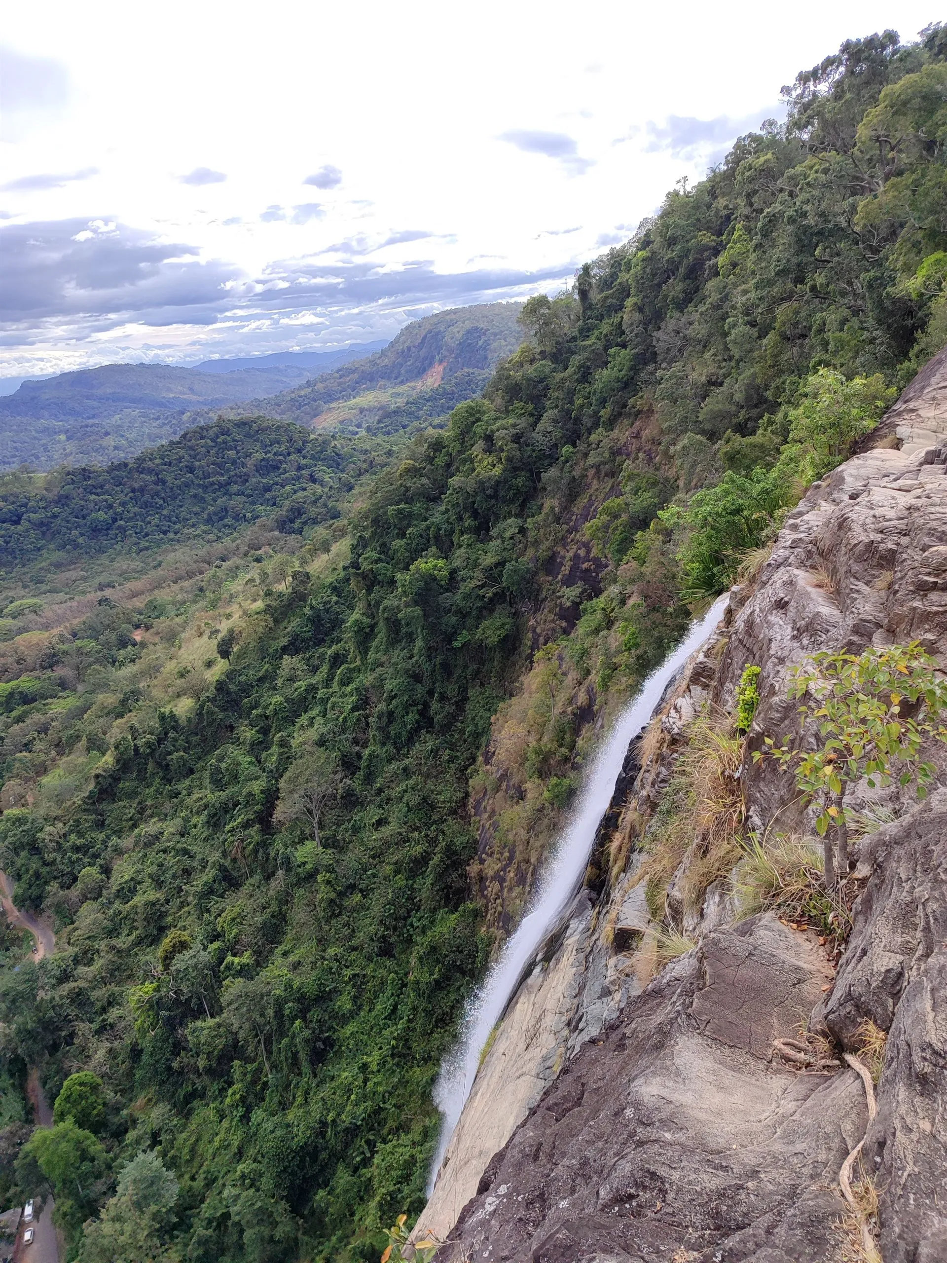 The lip of a waterfall dropping away into the valley below
