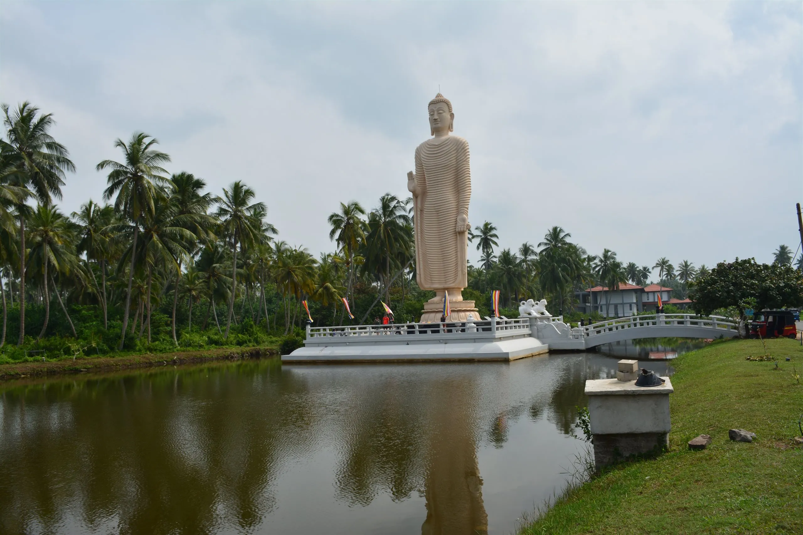 The tall standing Buddha of the tsunami monument at Peraliya, beside the lagoon