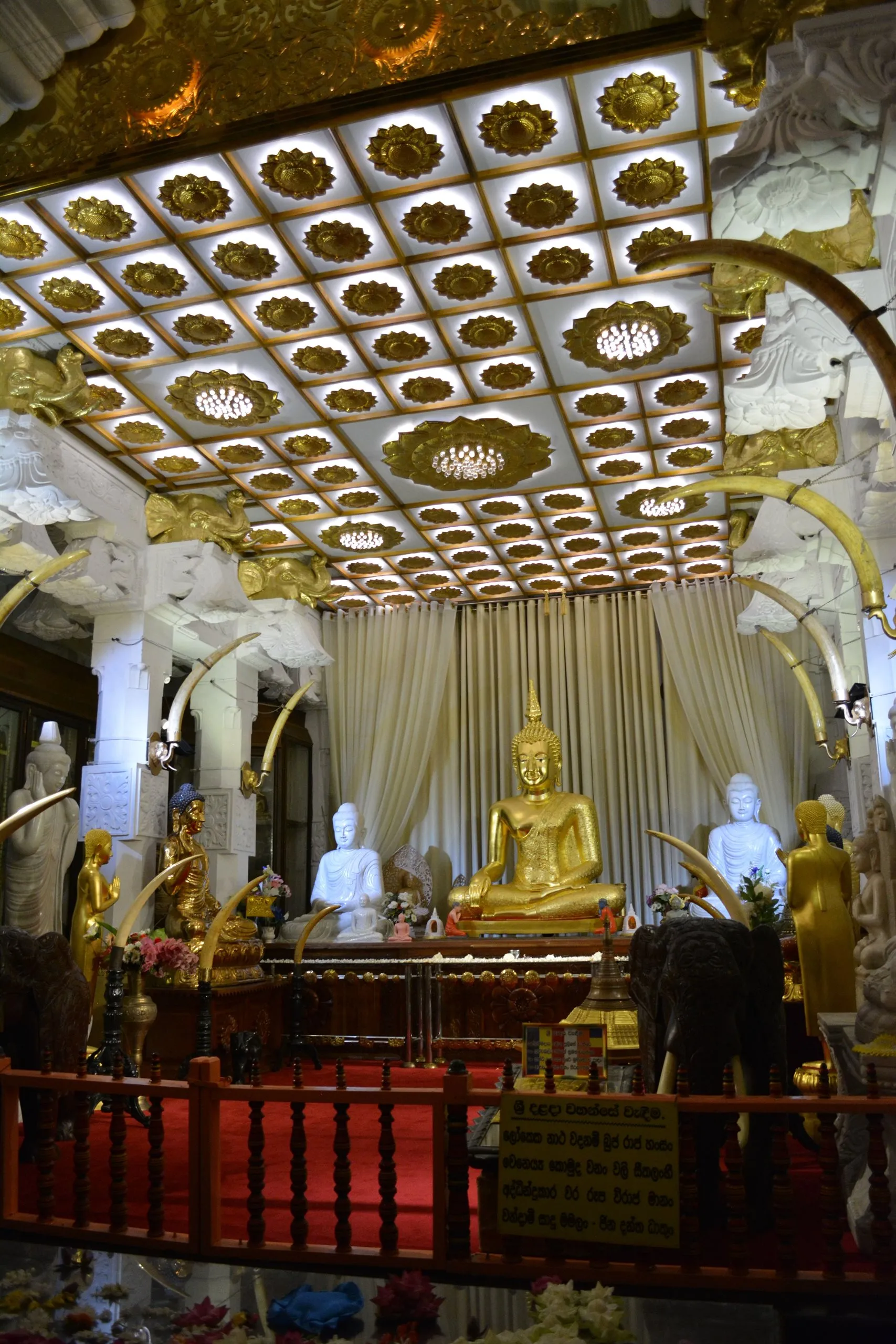 Rows of Buddha statues in an ornate shrine chamber