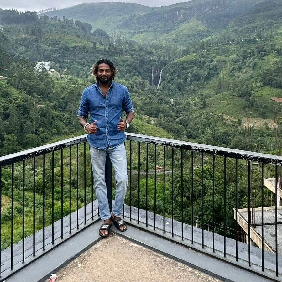 Gayan at a viewpoint above the tea hills and a waterfall